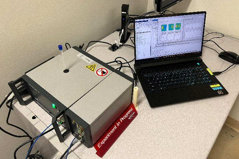 Scientific instruments on a desk with laptop