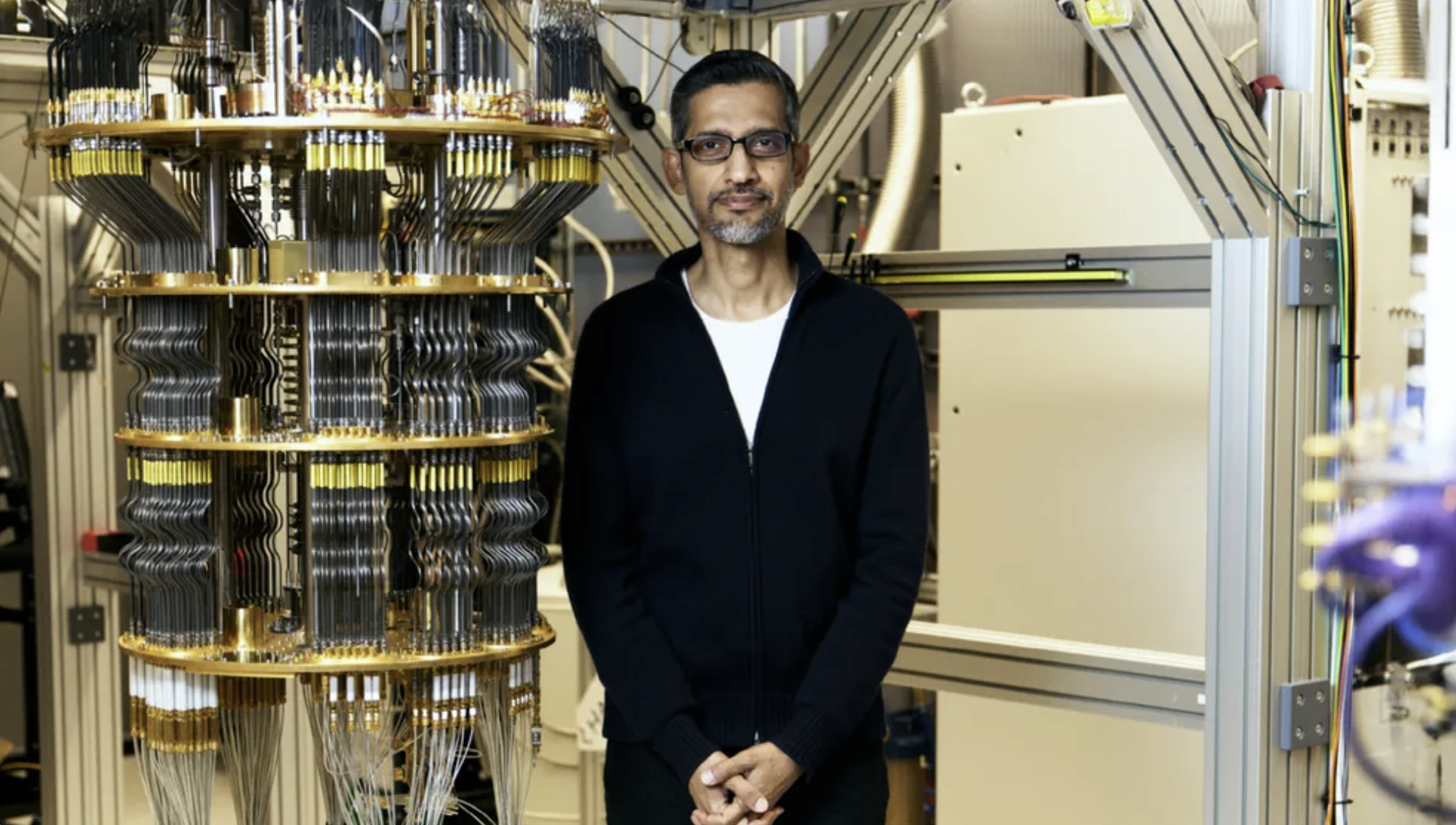 Sundar Pichai standing next to a quantum computer